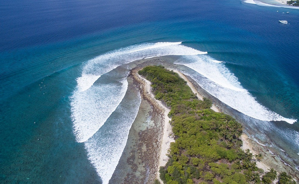 Aerial of surfing breaks. Four Seasons Kuda Huraa, Maldives Luxury Surfing. 