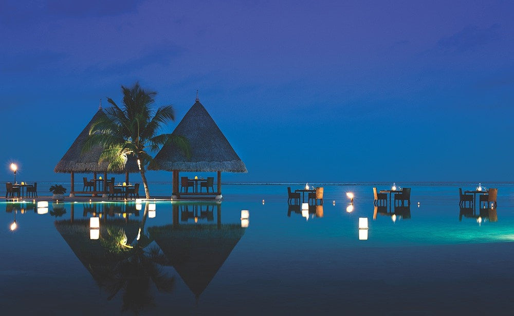 Sunset pool view. Four Seasons Kuda Huraa, Maldives Luxury Surfing.