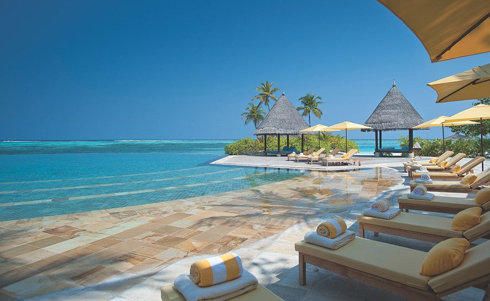 Relax by the pool. Four Seasons Kuda Huraa, Maldives Luxury Surfing.